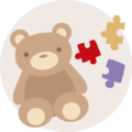 Ein niedlicher, brauner Teddy mit bunten Puzzlestücken daneben